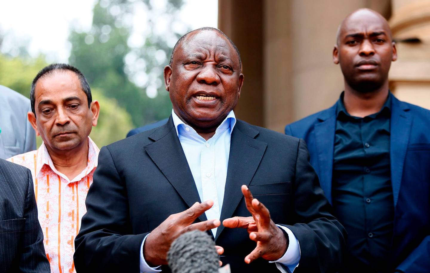 South African President Cyril Ramaphosa (C) conducts a media briefing at the end of a meeting with various business leaders and political party leaders on matters relating to the COVID-19 outbreak at the Union Buildings in Pretoria on March 22, 2020. (Photo by Phill Magakoe / AFP)