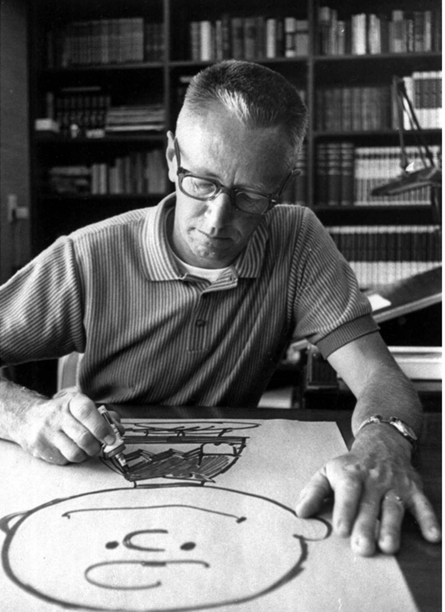 FILE--Cartoonist Charles Schulz draws a picture of his cartoon character Charlie Brown in his Sebastopol, Calif. home in this 1966 file photo. Before "Peanuts," Charles Schulz taught art with two guys named Charles Brown and Linus Maurer. He dated a little red-haired girl who crushed his heart. He felt loss, isolation and a burning passion to be a cartoonist. (AP Photo/File)