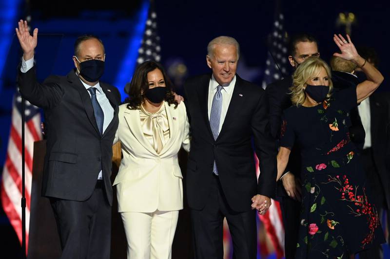TOPSHOT - US President-elect Joe Biden and Vice President-elect Kamala Harris stand with spouses Jill Biden and Doug Emhoff after delivering remarks in Wilmington, Delaware, on November 7, 2020, after being declared the winners of the presidential election. (Photo by Jim WATSON / AFP)