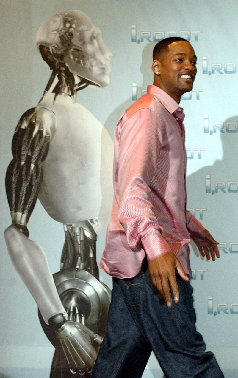 US actor Will Smith poses for the photographers in front of the movie poster during a photocall prior to the German premiere of his latest film "I,ROBOT" in Berlin Monday, Aug. 2, 2004. (AP Photo/Roberto Pfeil)