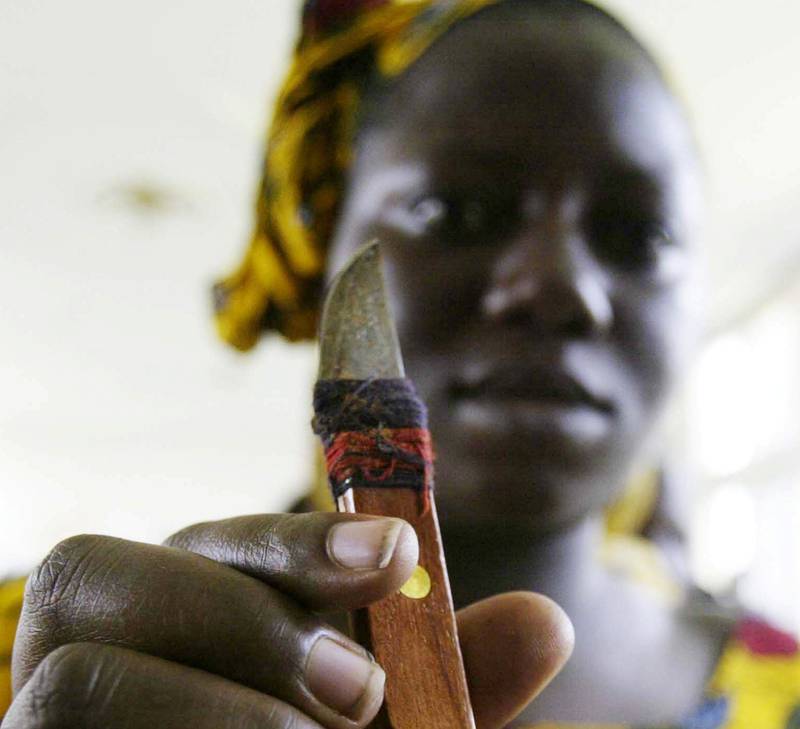 En kvinne fra Malis naboland Elfenbenskysten viser fram kniven som hun bruker til å kjønnslemleste. 