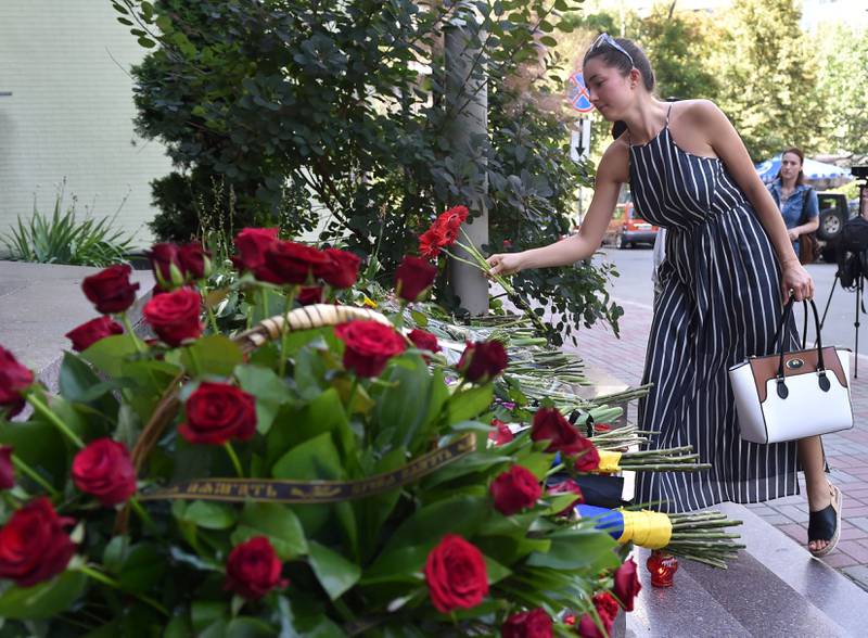 SYMPATI: En kvinne legger ned blomster utenfor den franske ambassaden i Kiev. FOTO: NTB SCANPIX