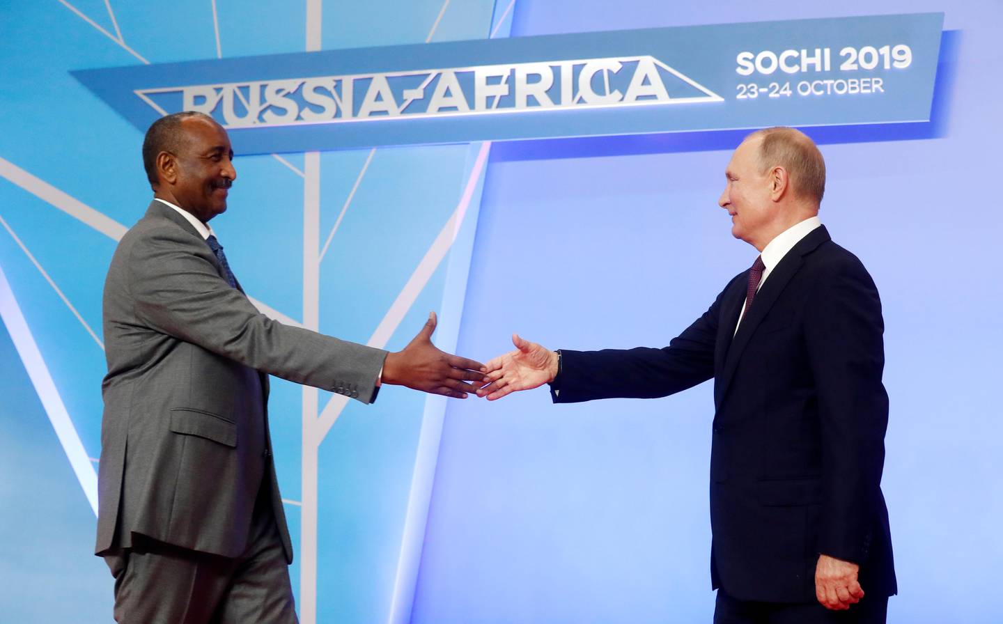 Russian President Vladimir Putin, right, greets President of the Sovereignty Council of Sudan Abdel Fattah Abdelrahman Burhan during a welcome ceremony of the Russia-Africa summit in the Black Sea resort of Sochi, Russia, Wednesday, Oct. 23, 2019. (AP Photo/Sergei Chirikov, pool photo via AP)