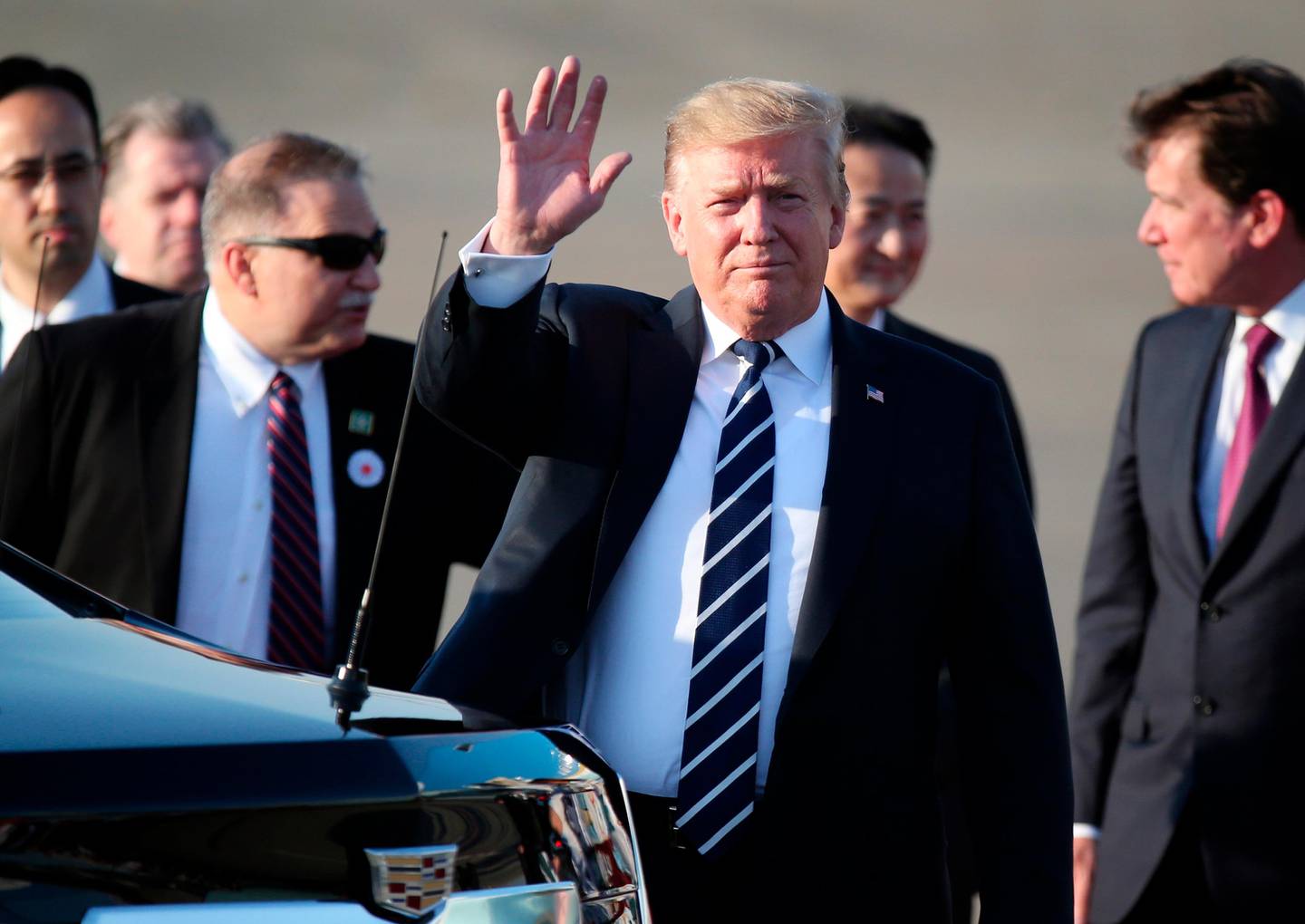 U.S. President Donald Trump waves as he arrives at the Haneda International Airport Saturday, May 25, 2019, in Tokyo. (AP Photo/Koji Sasahara, Pool)