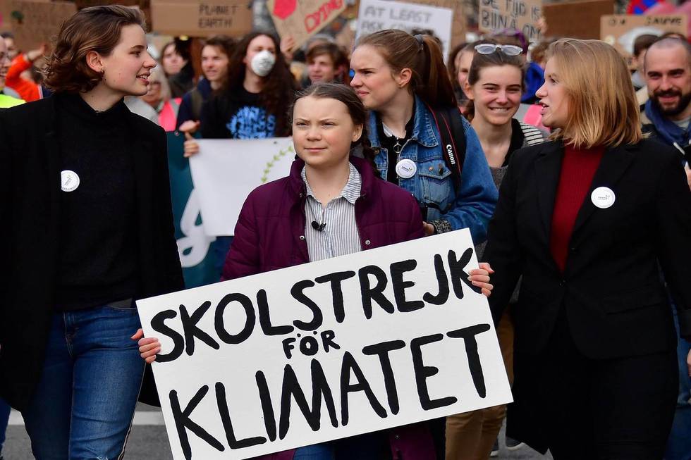 Swedish 16-years-old climate activist Greta Thunberg (C) takes part in a march for the environment and the climate organised by students, in Brussels, on Februaru 21, 2019. - Greta Thunberg, the 16-year-old Swedish climate activist who has inspired pupils worldwide to boycott classes, urged the European Union on February 21, 2019 to double its ambition for greenhouse gas cuts. (Photo by EMMANUEL DUNAND / AFP)
