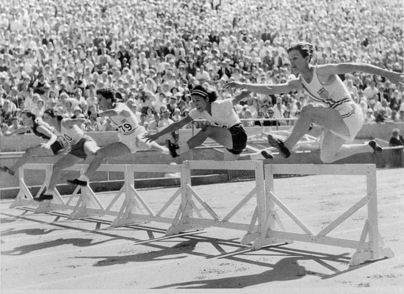 FILE - In this Aug. 3, 1932, file photo, Mildred "Babe" Didrikson, right, of Dallas, clears the first hurdle on her way winning the first heat of the 80-meter hurdles in 11.8 seconds, breaking the Olympic record of 12.2 second, at the Olympics in Los Angeles. Didrikson, along with fellow Olympic champions Michael Johnson and Dan O'Brien, will be among the 24 athletes inducted into the Hall of Fame being opened by track and field's governing body later this year.  (AP Photo/File)