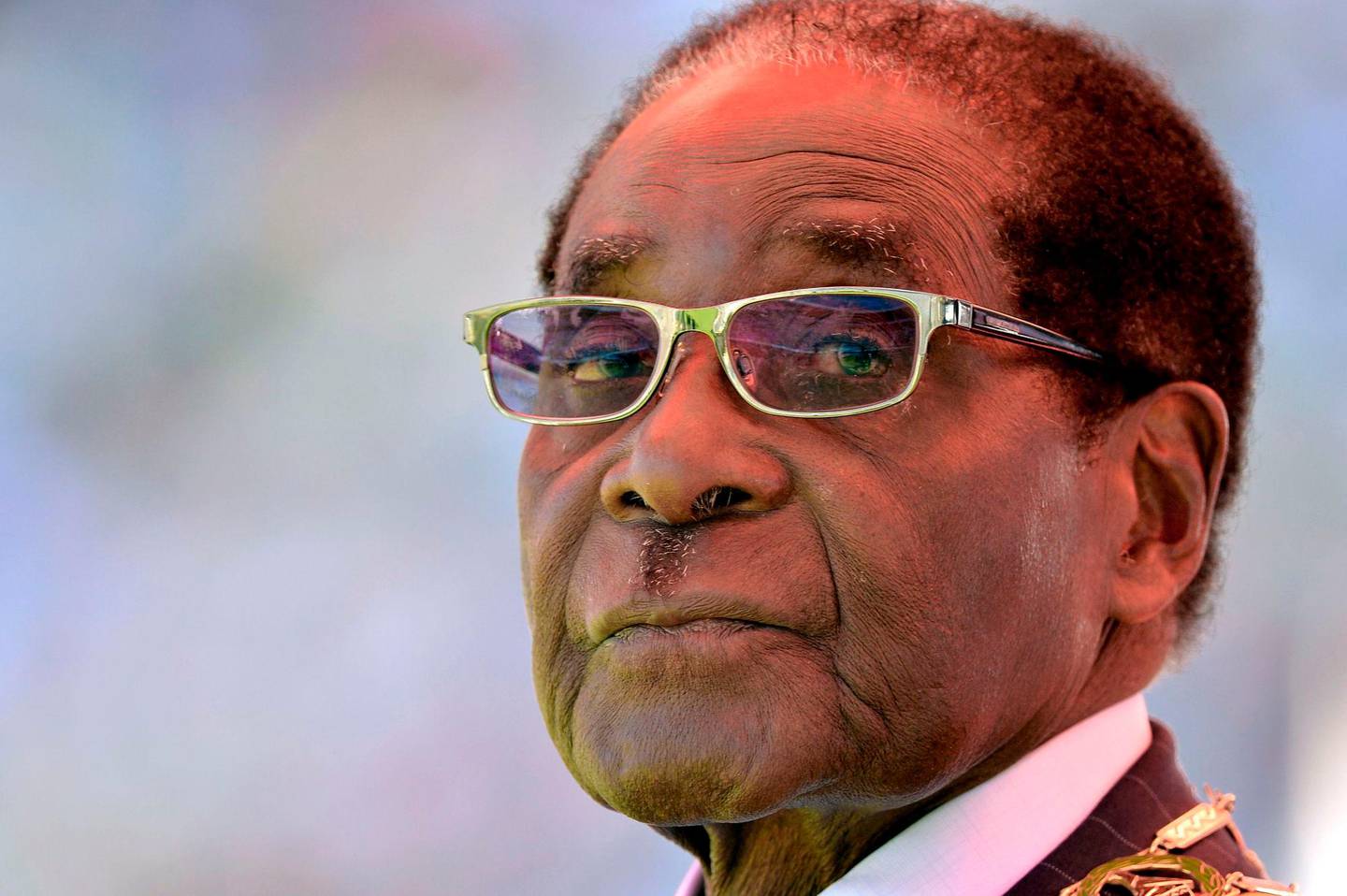 (FILES) This file photo taken on August 22, 2013 shows then Zimbabwean President Robert Mugabe looking on during his inauguration and swearing-in ceremony at the 60,000-seater sports stadium in Harare.  
Zimbabwe's former president Robert Mugabe, 93, who was ousted from power last month, has flown to Singapore for a medical check-up, his former spokesman said on December 14, 2017. Mugabe and his wife Grace have not been seen in public since he was forced to resign after a military takeover brought a sudden end to his authoritarian 37-year reign.
 / AFP PHOTO / ALEXANDER JOE