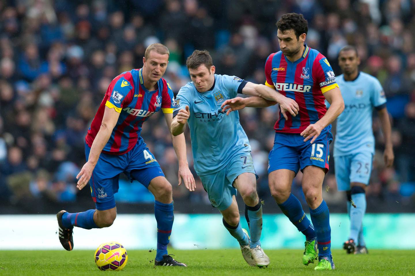Manchester City's James Milner, centre, fights for the ball against Crystal Palace's Mile Jedinak, right, and Brede Hangeland during the English Premier League soccer match between Manchester City and Crystal Palace at the Etihad Stadium, Manchester, England, Saturday Dec. 20, 2014. (AP Photo/Jon Super)  