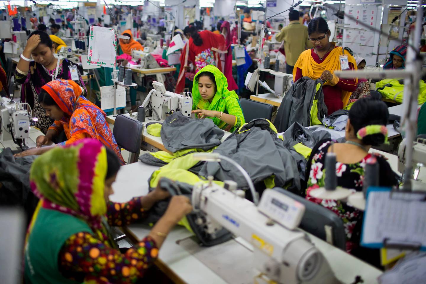 FILE - In this April 19, 2018 photo, Bangladeshis work at Snowtex garment factory in Dhamrai, near Dhaka, Bangladesh. A group set up by European clothing brands that has monitored factory safety in Bangladesh for years plans to leave, with its duties being assumed by a local group including unions and industry figures in the world's second-largest garment manufacturer. The European group and a separate North American group were formed after the collapse of Rana Plaza, a building housing five garment factories that made clothing for international brands. The departure, which officials said Thursday, Jan. 16, 2019, was planned for May, follows a protracted tussle with garment manufacturers who wanted Bangladesh's government to form a local watch group to monitor the sector. (AP Photo/A.M. Ahad, File)