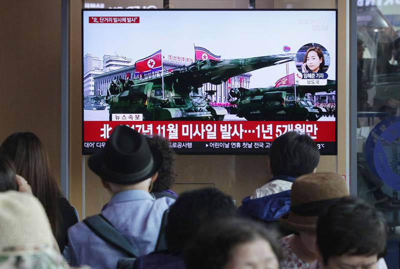People watch a TV showing a file footage of North Korea's missiles during a military parade in Pyongyang during a news program at the Seoul Railway Station in Seoul, South Korea, Saturday, May 4, 2019.  North Korea on Saturday fired several unidentified short-range projectiles into the sea off its eastern coast, the South Korean Joint Chiefs of Staff said, a likely sign of Pyongyang's growing frustration at stalled diplomatic talks with Washington meant to provide coveted sanctions relief in return for nuclear disarmament.The signs read: "North Korea fired a missile November in 2017." (AP Photo/Ahn Young-joon)
