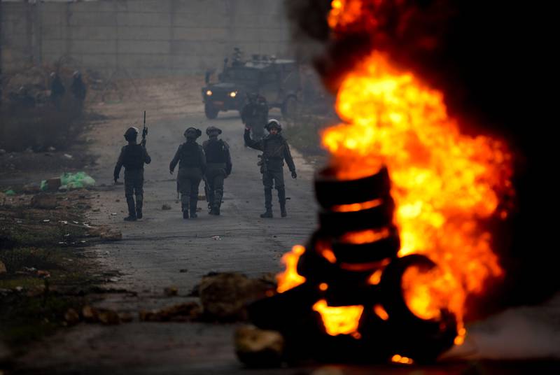 Israeli forces clash with Palestinians during a protest against President Donald Trump's Mideast initiative in the West Bank city of Ramallah. Tuesday, Feb. 11, 2020. Palestinian President Mahmoud Abbas plans to deliver a speech at the U.N. later in the day, but members will not be voting on a draft resolution. Palestinian officials denied the resolution had been pulled, but diplomats said many members, including European countries, rejected the language in a draft that had circulated. (AP Photo/Majdi Mohammed).