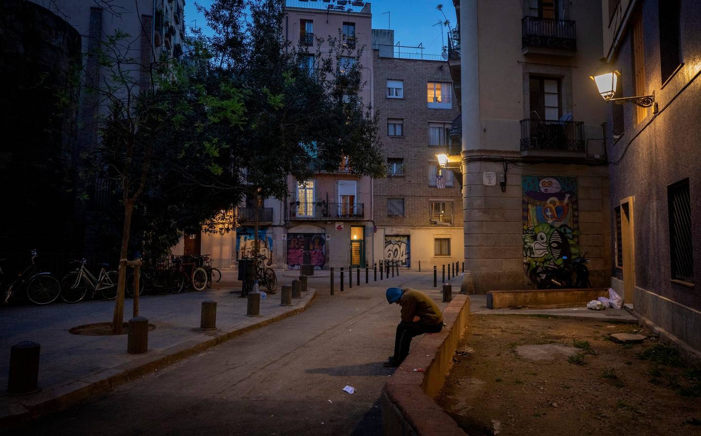 In this Friday, March 20, 2020 photo, Gana Gutierrez sits in an empty street in Barcelona, Spain. "It is as if there has been a nuclear explosion and they are all sheltering in the bunker. Only us, the homeless, are left out " explains 36-year-old Gana, who has lived on the street for more than 8 years and comments that the slogan. "quedateencasa" (Stayathome) is only for those who have a roof over their heads but not for them. (AP Photo/Emilio Morenatti)