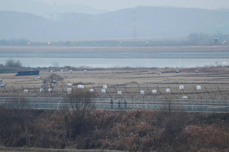 FILE - In this Dec. 16, 2019, file photo, South Korean army soldiers patrol along the barbed-wire fence in Paju, South Korea, near the border with North Korea. The Joint Chiefs of Staffs in Seoul said that North Korean troops fired several bullets at a South Korean guard post inside the heavily fortified border between the countries on Sunday, May 3, 2020. (AP Photo/Ahn Young-joon, File)