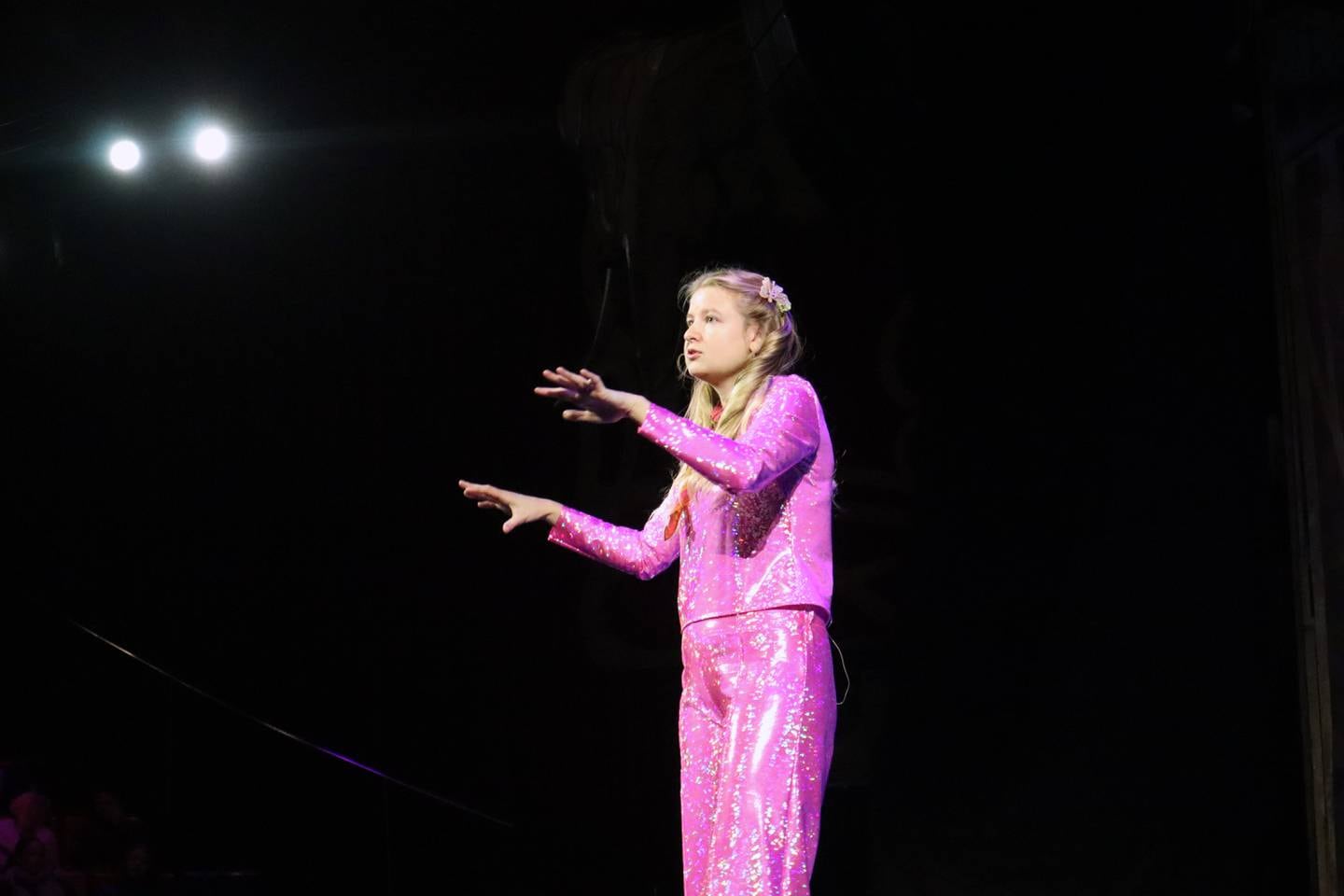 Young woman wearing bright pink clothes.