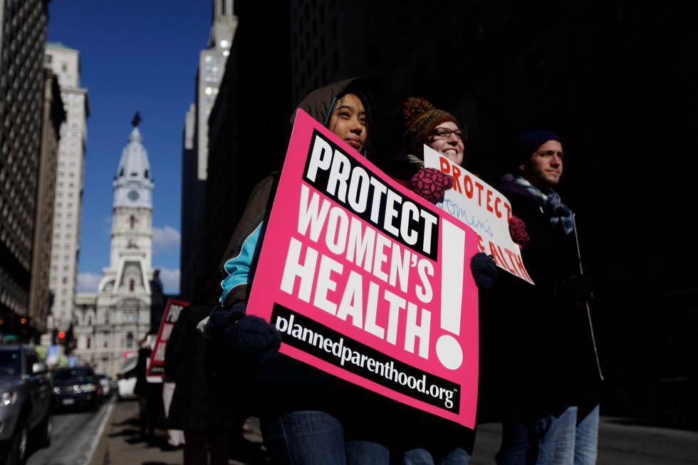 Abortion rights advocates Grace Fried, center, Claire Roden and David Tuke demonstrate in view of Philadelphia City Hall Friday, Jan. 21, 2011 on the eve of the anniversary of the 1973 Roe v. Wade Supreme Court decision that legalized abortion. (AP Photo/Matt Rourke)