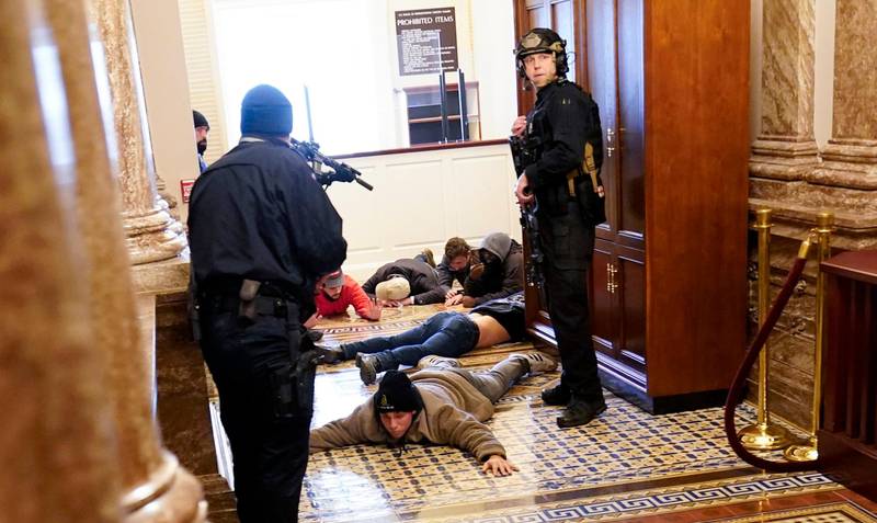 U.S. Capitol Police hold protesters at gun-point near the House Chamber inside the U.S. Capitol on Wednesday, Jan. 6, 2021, in Washington. (AP Photo/Andrew Harnik)