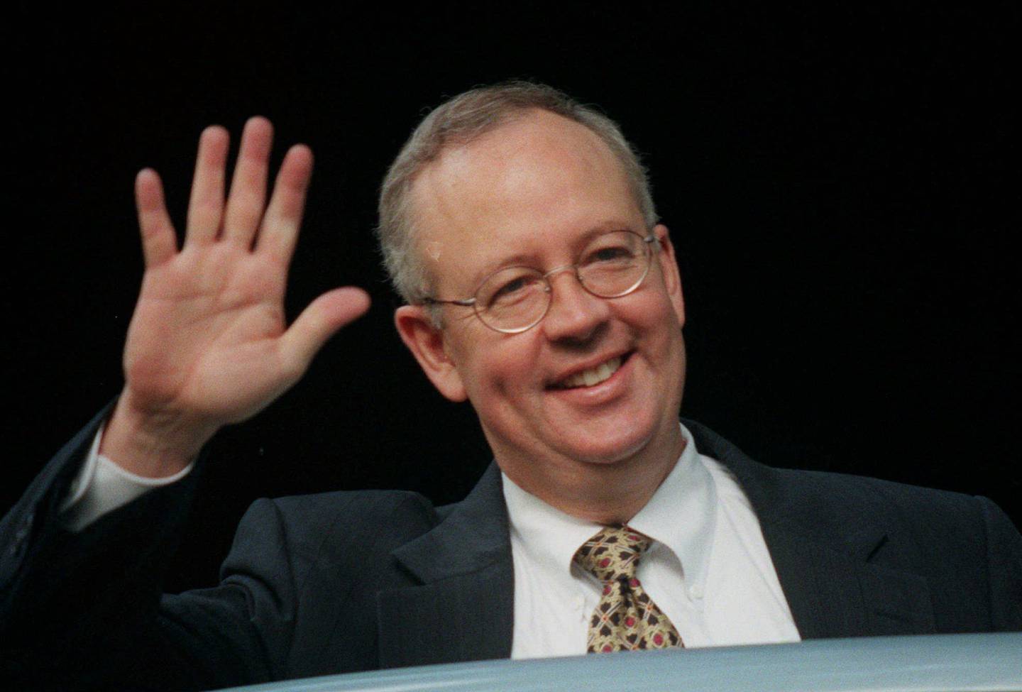 
Special prosecutor Ken Starr waves as he enters his car outside his home in McLean, Va. Thursday July 16, 1998. President Clinton's Secret Service lead agent, Larry Cockell has entered the Federal Court in Washington to appear before the grand jury under subpoena to testify in the Monica Lewinsky investigation. (AP Photo/Khue Bui)
