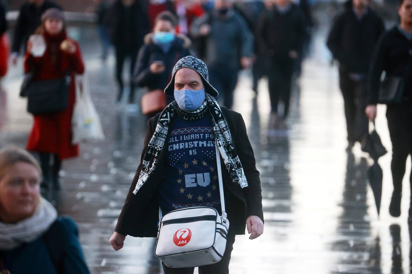 People walk across London Bridge as the spread of the coronavirus disease (COVID-19) continues in London, Britain, December 15, 2020. REUTERS/Hannah McKay