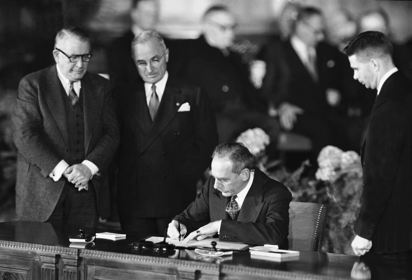 FILE - Secretary of State Dean Acheson signs the Atlantic defense treaty for the United States, April 4, 1949. Vice President Alben W. Barkley, left, and President Harry Truman converse during the signing. Finland and Sweden are nearing decisions on whether to ditch their long-standing policy of military nonalignment and join NATO in the wake of Russia's invasion of Ukraine. Finnish President Sauli Niinisto is expected to announce his stance on NATO membership on Thursday, May 12, 2022. (AP Photo/File)