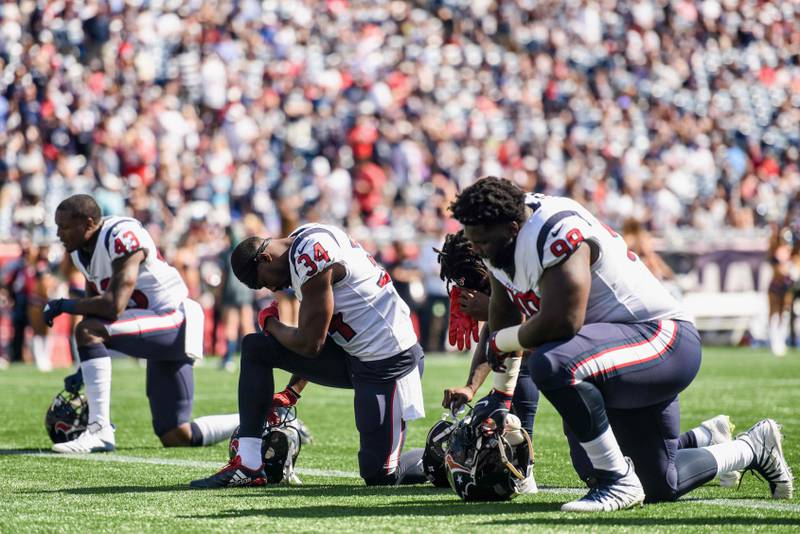 (FILES) This file photo taken on September 23, 2017 shows members of the Houston Texans kneel before a game against the New England Patriots at Gillette Stadium in Foxboro, Massachusetts.   
Americans largely disapprove of athletes staging protests during the national anthem but they also do not like President Donald Trump's handling of the issue, according to two opinion polls published on September 29, 2017. Fifty-two percent of the people surveyed by CBS News said they disapprove of protests during The Star-Spangled Banner while 38 percent said they approve.
 / AFP PHOTO / GETTY IMAGES NORTH AMERICA / Billie Weiss