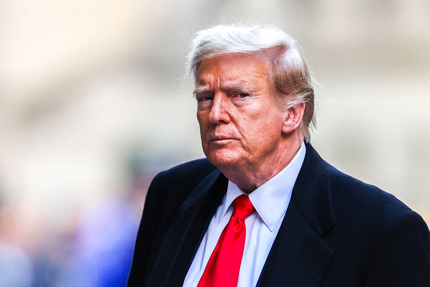 (FILES) Former US President Donald Trump arrives at 40 Wall Street after his court hearing to determine the date of his trial for allegedly covering up hush money payments linked to extramarital affairs in New York City on March 25, 2024. Embattled former US president Donald Trump posted a $175 million bond in his New York civil fraud case April 1, 2024, avoiding payment of a $454 million penalty while his case winds through the appeals process. (Photo by Charly TRIBALLEAU / AFP)