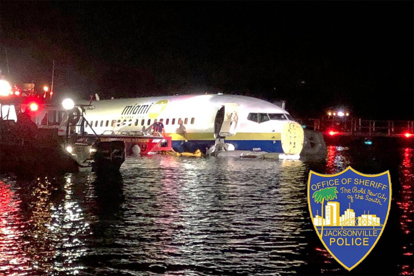 In this photo released by the Jacksonville Sheriff's Office, authorities work at the scene of a plane in the water in Jacksonville, Fla., Friday, May 3, 2019. Officials say a charter plane traveling from Cuba to north Florida ended up in a river at the end of a runway. A Naval Air Station Jacksonville news release says a Boeing 737 arriving from Naval Station Guantanamo Bay, Cuba, crashed into the St. Johns River Friday night. (Jacksonville Sheriff's Office via AP)