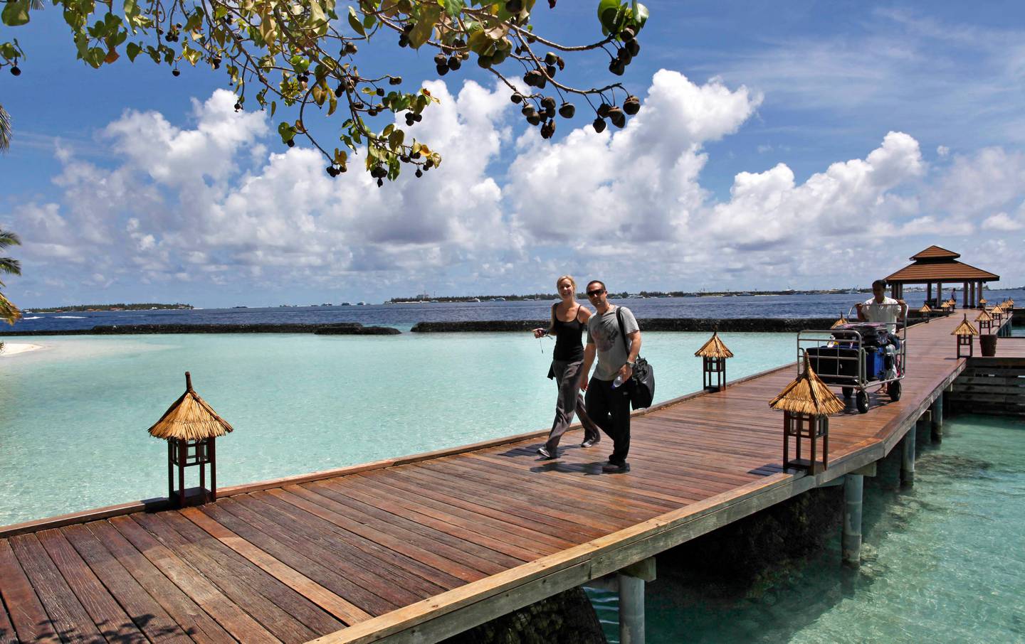 Foreign tourists arrive in a resort in the Kurumba island in Maldives, Sunday, Feb. 12, 2012. The Maldives' new president expanded his Cabinet on Sunday to include religious conservatives who have been demanding the introduction of strict Islamic laws in the Indian Ocean nation that relies on high-end tourism. Tourism is the main industry in the Maldives, a chain of nearly 1,200 islands off southern India blessed with sandy beaches and coral. Most resorts remained mostly untouched by the protests in Male and the southernmost atoll, Addu. (AP Photo/ Gemunu Amarasinghe)