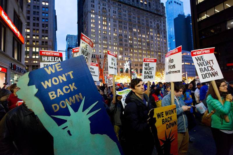 Demonstranter i New York som demonstrerer for å øke minstelønnen til 15 dollar per time. Bildet er fra 2016, men kampen for høyere minstelønn fortsetter fremdeles. Foto: Mark Lennihan / AP