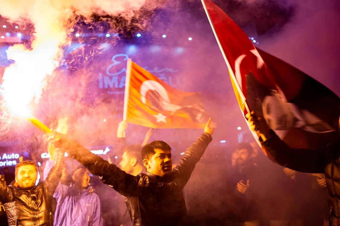 Supporters of the main opposition Republican People's Party (CHP) wave flags and light up torches to celebrate the local election in Istanbul, Turkey on 1 April 2019. (Photo by Yasin AKGUL / AFP)