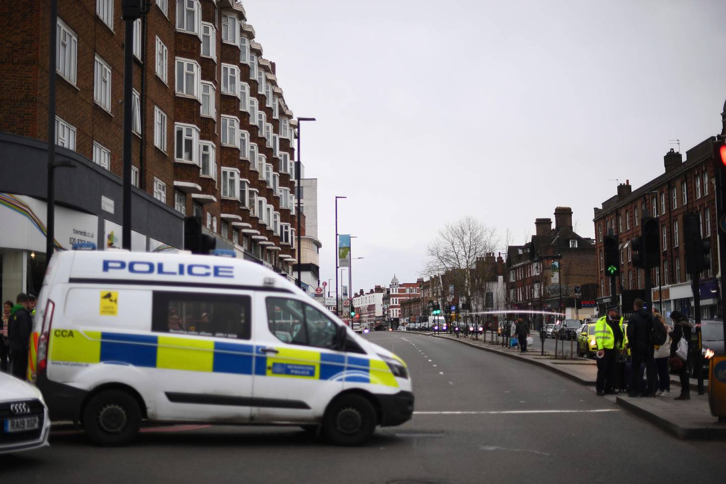 Police at the scene after an incident in Streatham, London, Sunday Feb. 2, 2020. London police say officers shot a man during a terrorism-related incident that involved the stabbings of a number of people. (Victoria Jones/PA via AP)