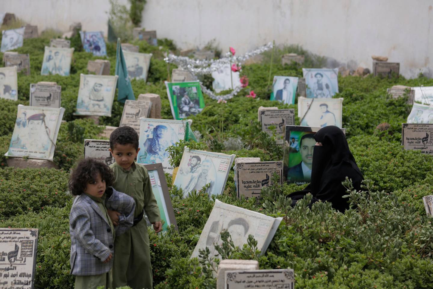 A Yemeni woman,offers prayers at the grave of her husband who was killed during Yemen's ongoing conflict, at a cemetery in Sanaa, Yemen, Friday, July 3, 2020. (AP Photo/Hani Mohammed)