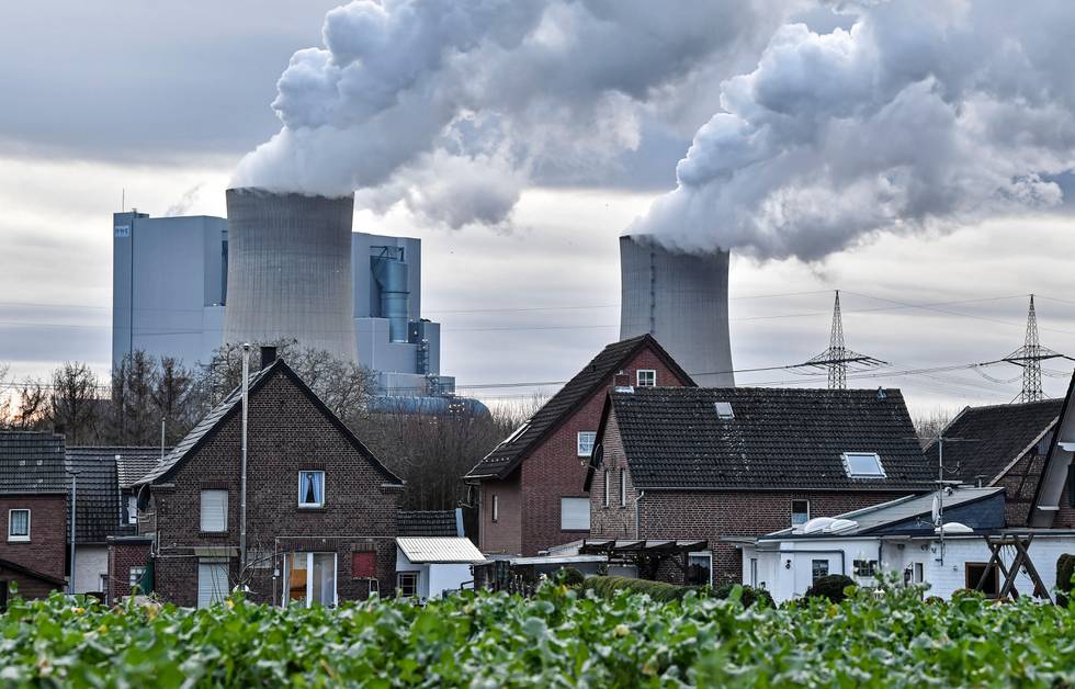 An RWE lignite-fired power station releases steam in Bergheim, Germany, Monday, Jan. 13, 2020. Germany plans an entirely coal phase out and to shut down all remaining coal-fired plants by 2038. (AP Photo/Martin Meissner)