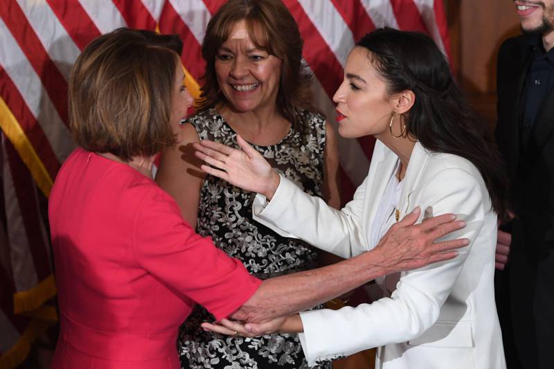 Speaker of the House Nancy Pelosi (L) greets Rep. Alexandria Ocasio-Cortez (R), D-NY, during the ceremonial swearing-in at the start of the 116th Congress at the US Capitol in Washington, DC, January 3, 2019. (Photo by SAUL LOEB / AFP)