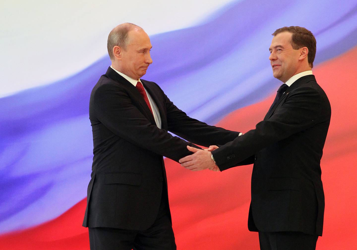 Russian President Vladimir Putin, left, and former President Dmitry Medvedev shakes hands at the inauguration ceremony in the Kremlin in Moscow on Monday, May 7, 2012. Vladimir Putin has been sworn in as Russia's president for a third term after four years as prime minister. (AP Photo/RIA Novosti Kremlin, Yekaterina Shtukina, Presidential Press Service)
