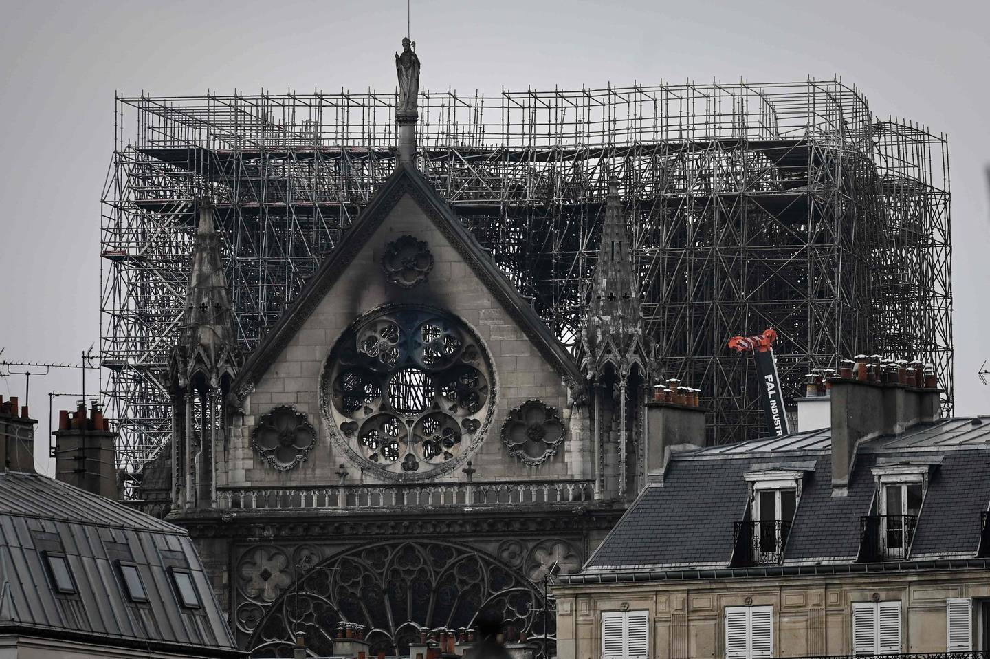 Scafolding which was errected for the renovation of the landmark Notre-Dame Cathedral, remains in place a day after a devastating fire destroyed the roof and other areas of the Gothic cathedral in central Paris on April 16, 2019. - A major fire broke out at the landmark Notre-Dame Cathedral in central Paris sending flames and huge clouds of grey smoke billowing into the sky on April 15, 2019 evening. French investigators probing the devastating blaze at Notre-Dame Cathedral questioned workers who were renovating the monument on April 16, 2019, as hundreds of millions of euros were pledged to restore the historic masterpiece. (Photo by Philippe LOPEZ / AFP)