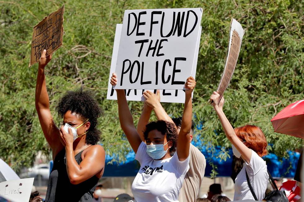 Protesters rally Wednesday, June 3, 2020, in Phoenix, demanding the Phoenix City Council defund the Phoenix Police Department. The protest is a result of the death of George Floyd, a black man who died after being restrained by Minneapolis police officers on May 25. (AP Photo/Matt York)