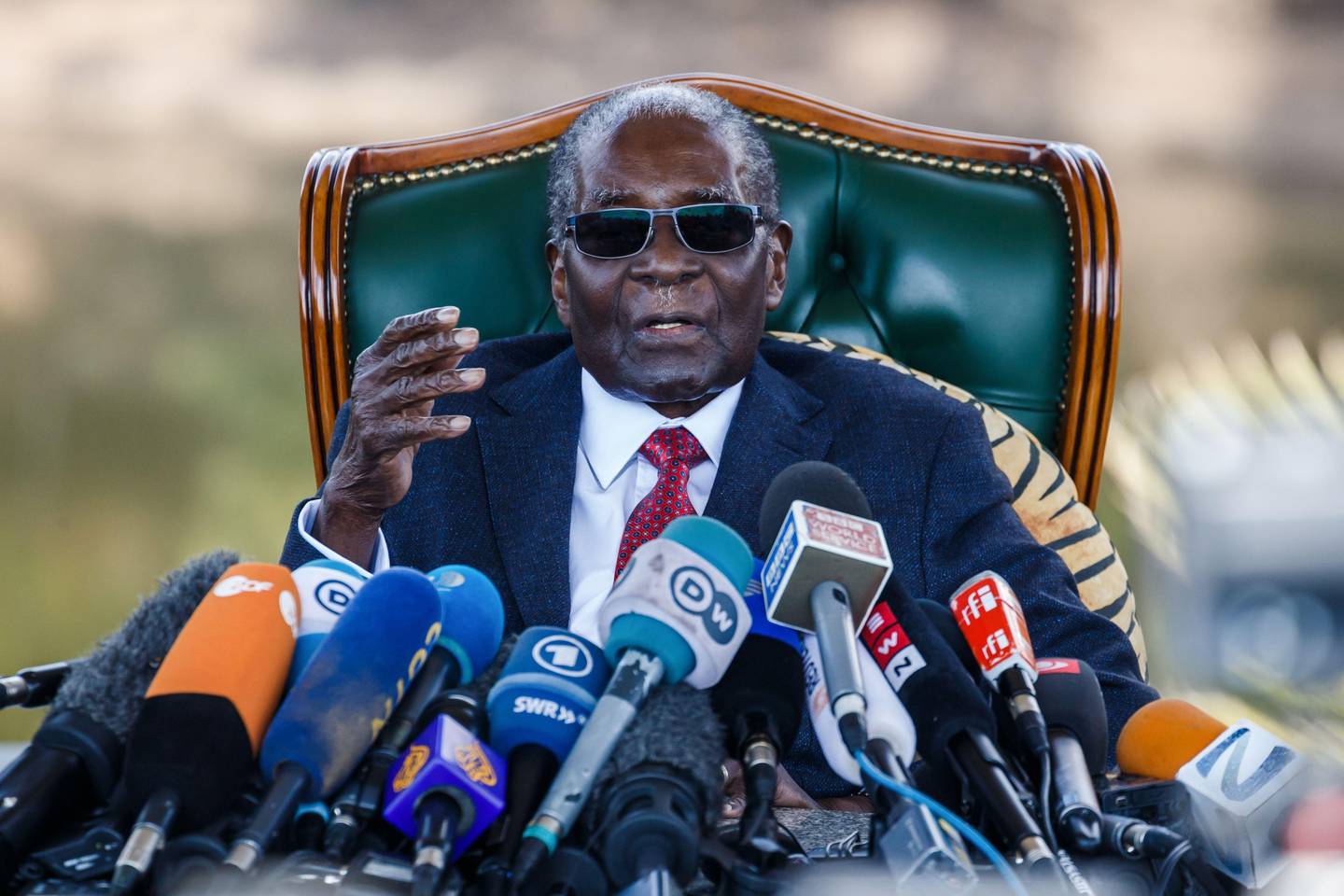 (FILES) In this file photo taken on July 29, 2018 former Zimbabwean President Robert Mugabe addresses media during a surprise press conference at his residence "Blue Roof " in Harare, on the eve of the country's first election since he was ousted from office last year. - Mugabe, who held power since independence from British colonial rule in 1980, presided over Zimbabwe's decline from a regional power with huge potential, to a ruined country from which millions fled. Many hoped his fall would mark a new era for the country and a re-birth of its economy, but Chihota says business at his plastic manufacturing firm is at its slowest since he started eight years ago. (Photo by Jekesai NJIKIZANA / AFP)