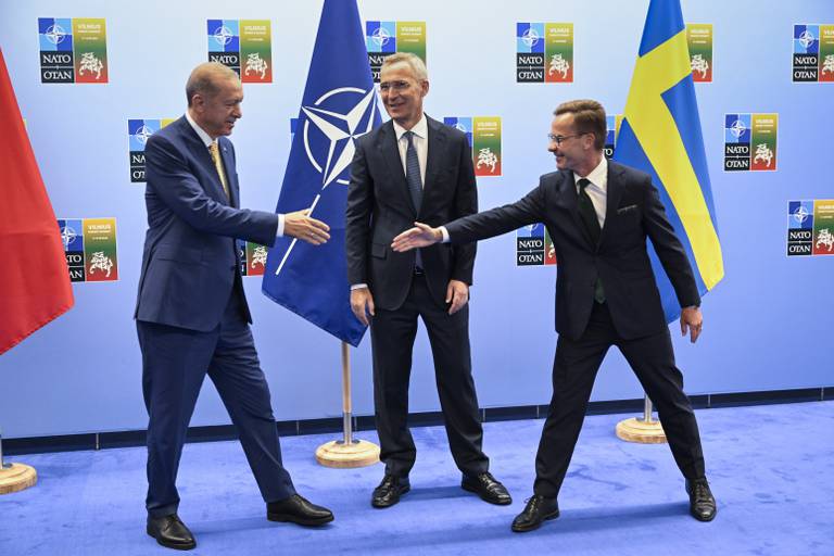 FILE - Turkish President Recep Tayyip Erdogan, left, and Swedish Prime Minister Ulf Kristersson shake hands next to NATO Secretary-General Jens Stoltenberg prior to their meeting, on the eve of a NATO summit, in Vilnius, Monday, July 10, 2023. Turkish President Recep Tayyip Erdogan's abrupt approval of Sweden's NATO bid came after a year of objections to Stockholm to joining the defense alliance. (Henrik Montgomery/TT News Agency via AP, File)
