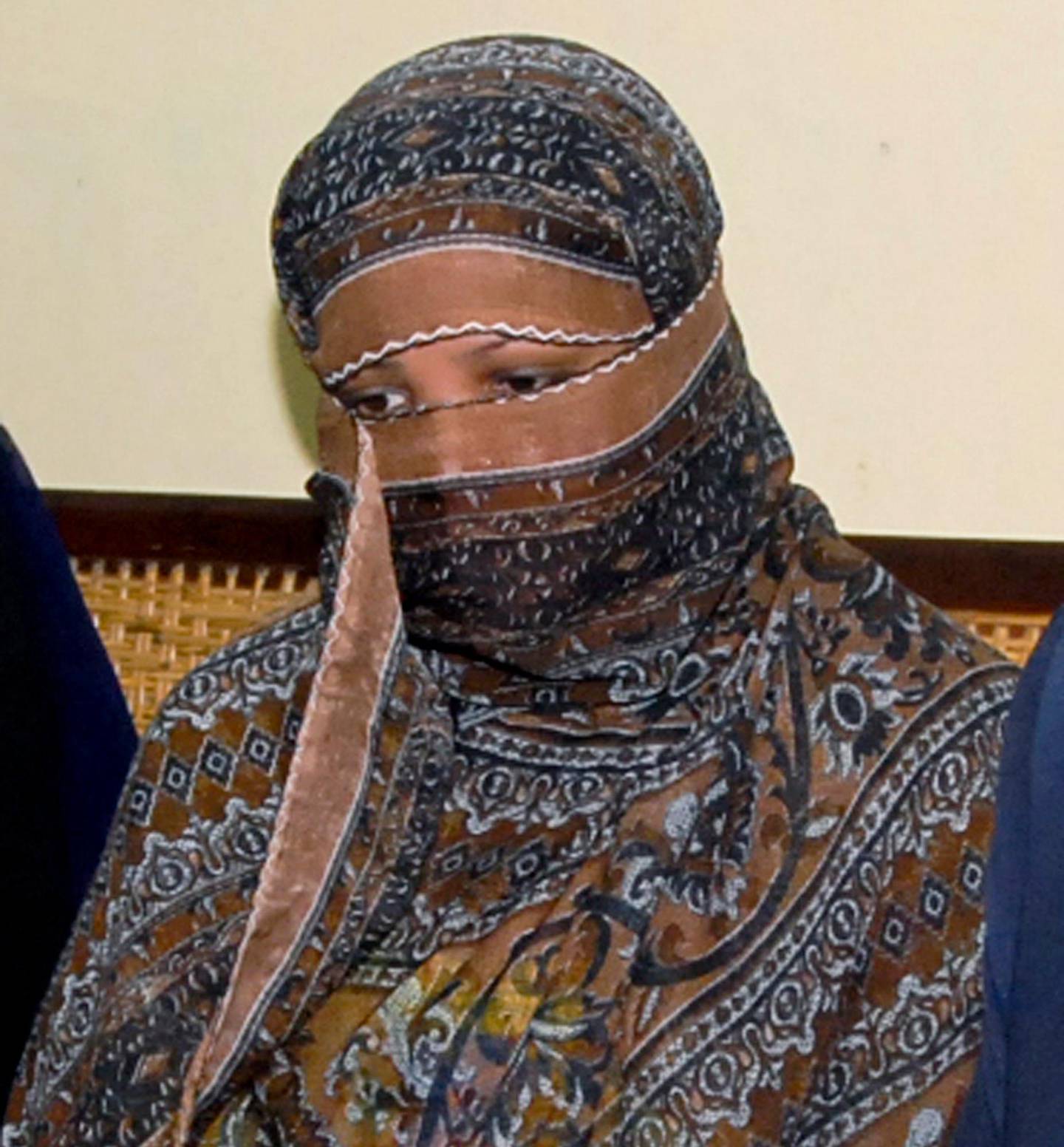 FILE - In this Nov. 20, 2010, file photo, Asia Bibi, a Pakistani Christian woman, listens to officials at a prison in Sheikhupura near Lahore, Pakistan. Italy is working to help relocate the family of a Pakistani Christian woman acquitted eight years after being sentenced to death for blasphemy, amid warnings from her husband that their life is in danger in Pakistan.  (AP Photo, File)