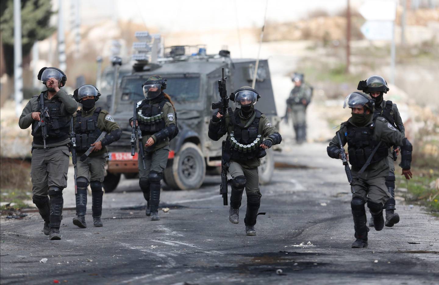 Israeli border police secure take position during clashes withe Palestinian demonstrators as they protest Middle East peace plan announced Tuesday by US President Donald Trump, at Beit El checkpoint, near the West Bank city of Ramallah, Saturday, Feb 1, 2020 (AP Photo/Majdi Mohammed)