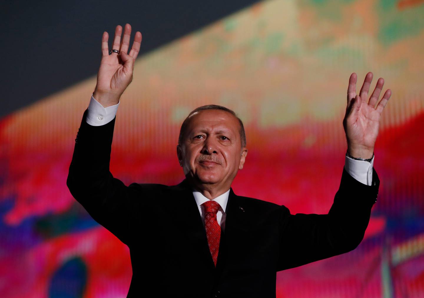 Turkey's President Recep Tayyip Erdogan waves to supporters following a rally to honour the victims of the July 15, 2016 failed coup attempt, part of the ceremonies marking the three-year anniversary, in Istanbul, Monday, July 15, 2019. Turkey is marking the third anniversary of the July 15 failed coup attempt against the government, with prayers and other events remembering its victims. (AP Photo/Lefteris Pitarakis)