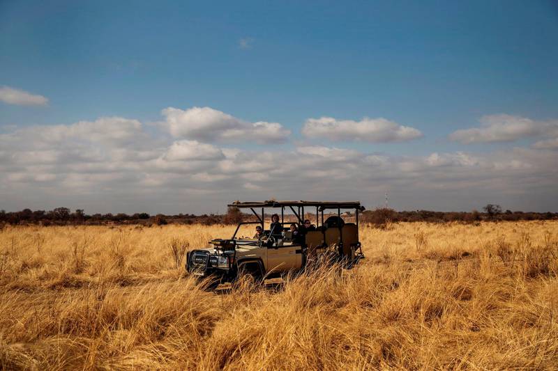 Tourists take part in a guided safari tour at the Dinokeng Game Reserve outside Pretoria, on August 7, 2020. - Visitors have flocked from the capital Pretoria and financial hub Johannesburg since the government allowed South Africans to travel for leisure within their provinces last week, bringing a small sliver of relief to the country's tourist industry, which has missed out on more than $3.9 billion in revenue since South Africa went into lockdown on March 27. (Photo by Michele Spatari / AFP)