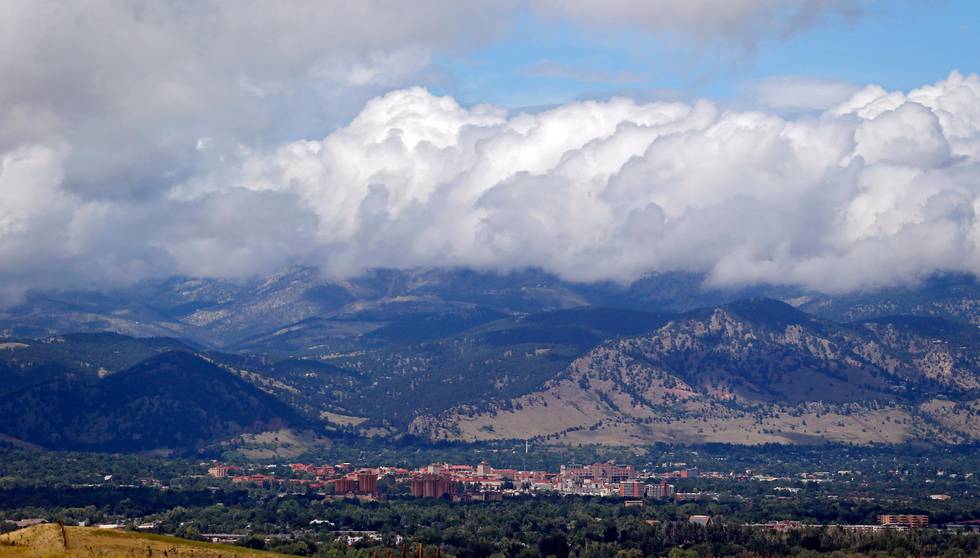 Storm clouds build over Boulder, Colo., and the Rocky Mountains on Friday, Sept. 13, 2013. A break in the weather brought sunshine and blue skies to the area for the first time this week. But more rain is in the forecast. Floodwaters cascaded downstream from the Colorado Rockies on Friday, spilling normally scenic mountain rivers and creeks over their banks and forcing thousands more evacuations in water-logged communities beset by days of steady rain. (AP Photo/Ed Andrieski)