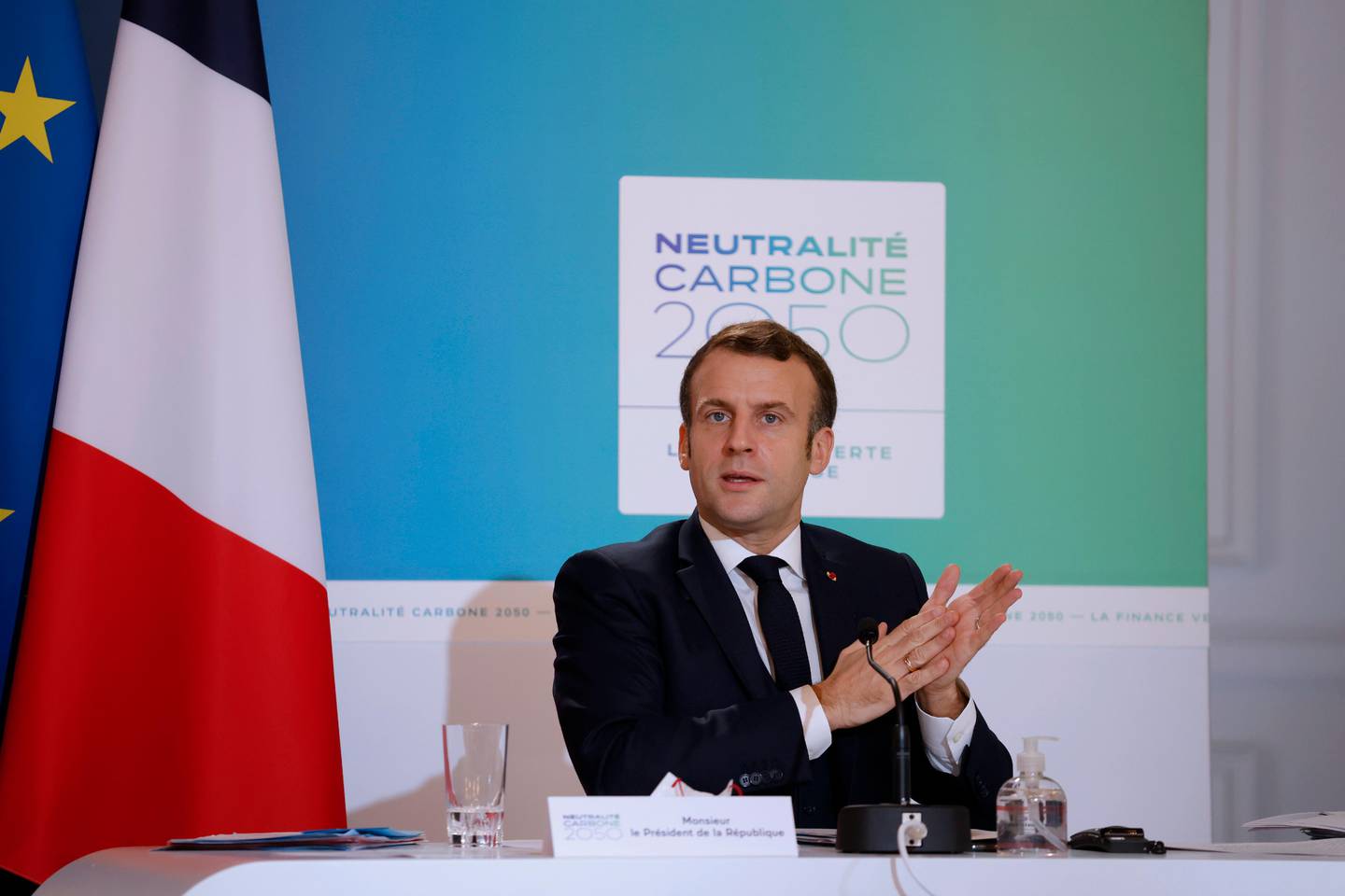 French President Emmanuel Macron speaks during a video conference meeting to mark the fifth anniversary of the Paris Climate agreement at the Elysee Palace in Paris, Saturday Dec.12, 2020. World leaders are staging a virtual gathering Saturday to celebrate the 5th anniversary of the Paris climate accord, which set a goal for keeping global temperatures from rising above levels that could have devastating consequences for mankind. (Yoan Valat, Pool via AP)