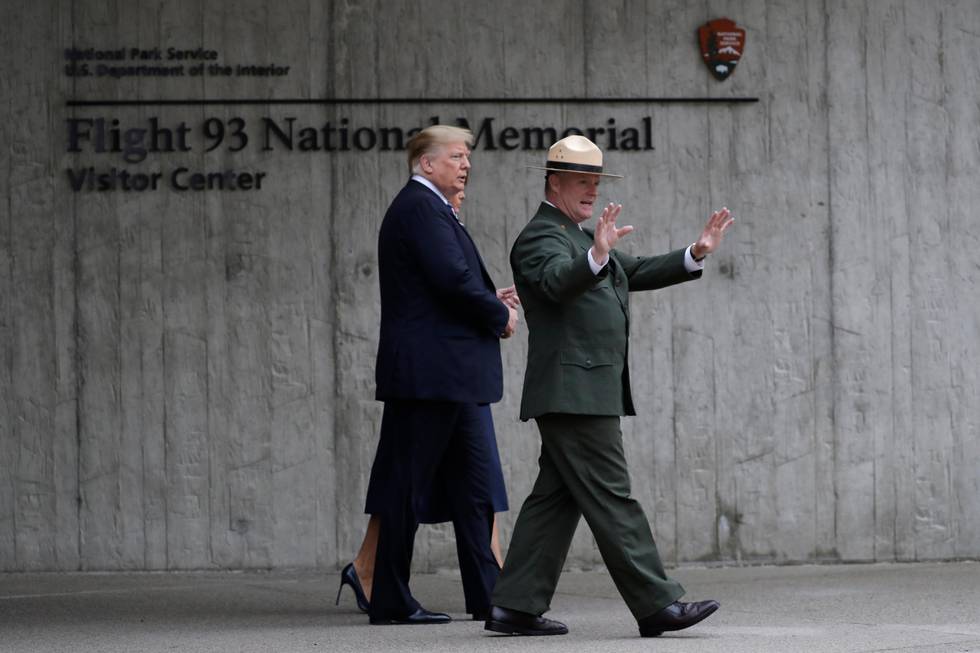 President Donald Trump and first lady Melania Trump, escorted by Stephen Clark, Superintendent of the National Parks of Western Pennsylvania, walk along the September 11th Flight 93 memorial, Tuesday, Sept. 11, 2018, in Shanksville, Pa., escorted by  (AP Photo/Evan Vucci)