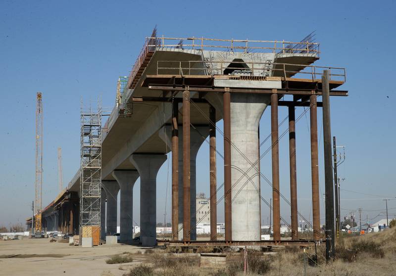 FILE - In this Dec. 6, 2017, file photo, one of the elevated sections of the high-speed rail is under construction in Fresno, Calif. Brian Kelly, the chief executive officer of The California High-Speed Rail Authority, said in a letter released Friday, Feb. 5, 2021, that a 119-mile segment of track in the Central Valley now won't be completed until 2023, a one-year delay. (AP Photo/Rich Pedroncelli, File)