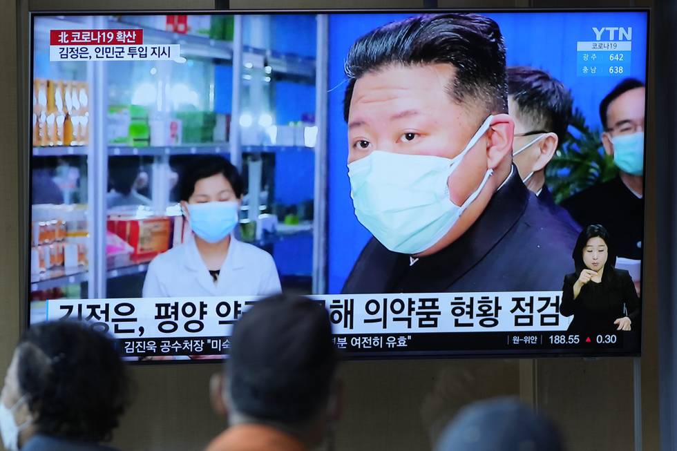 FILE - People watch a TV screen showing a news program reporting with an image of North Korean leader Kim Jong Un, at a train station in Seoul, South Korea on May 16, 2022. North Korea suggested Friday, July 1, 2022 its COVID-19 outbreak began in people who had contact with balloons flown from South Korea, a highly questionable claim that appeared to be an attempt to hold its rival responsible amid increasing tensions. (AP Photo/Lee Jin-man, File)
