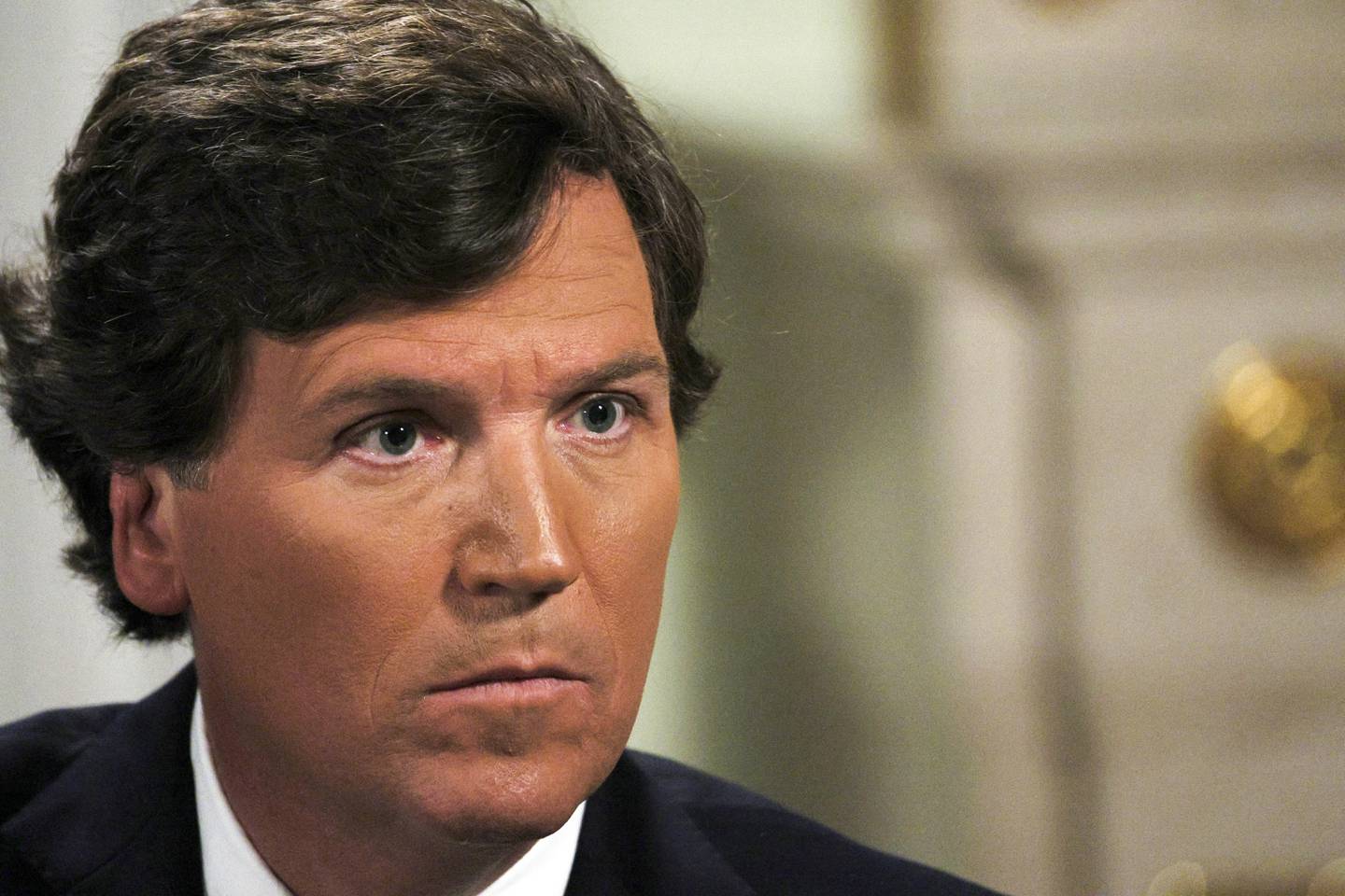 In this photo released by Sputnik news agency on Friday, Feb. 9, 2024, former Fox News host Tucker Carlson listens during an interview with Russian President Vladimir Putin, at the Kremlin in Moscow, Russia, Tuesday, Feb. 6, 2024. (Gavriil Grigorov, Sputnik, Kremlin Pool Photo via AP)