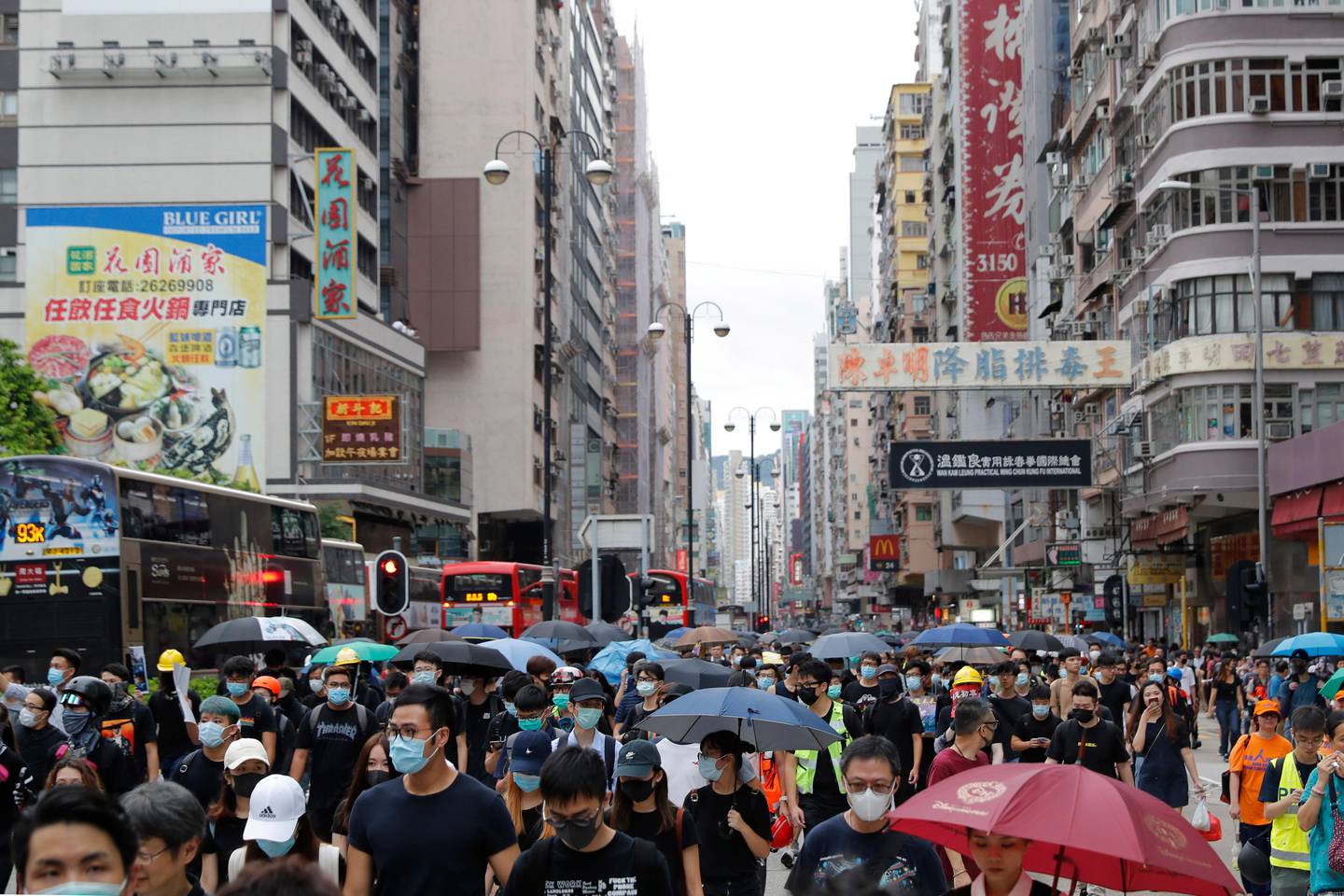 Protesters march through the Mong Kok neighborhood during a demonstration in Hong Kong, Saturday, Aug. 3, 2019. Hong Kong protesters ignored police warnings and streamed past the designated end point for a rally Saturday in the latest of a series of demonstrations targeting the government of the semi-autonomous Chinese territory. (AP Photo/Vincent Thian)