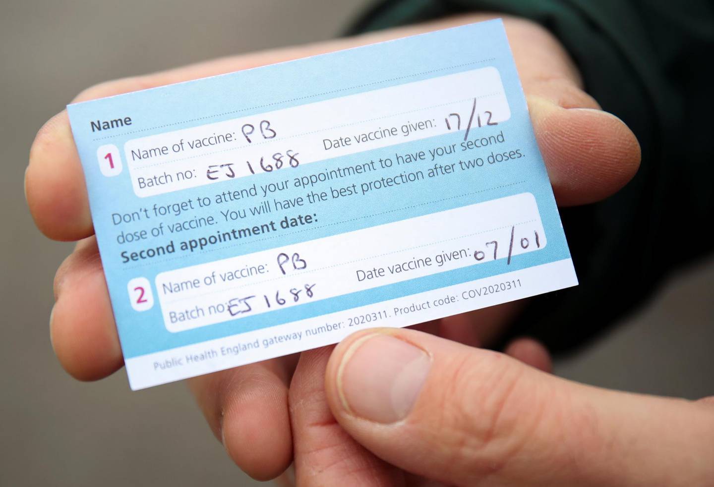 A COVID-19 vaccination record card is seen at a drive through vaccination centre, amid the outbreak of the coronavirus disease (COVID-19), in Hyde, Britain January 7, 2021. REUTERS/Molly Darlington